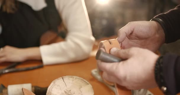 Leather craftsman working with a belt in a workshop — Wideo stockowe