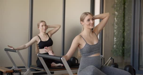 Two fit pregnant woman work on Pilates machines — Stok video