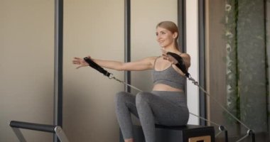 Makinede pilates yapan hamile bir model.