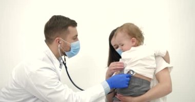 Mother with kids on checkup at pediatrician office