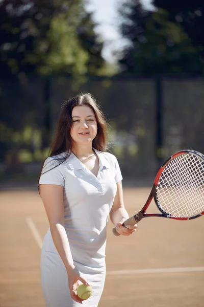 Caucasian female tennis player playing on the court outdoors — стокове фото