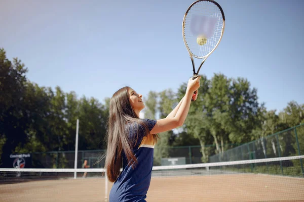 Caucasian female tennis player playing on the court outdoors — Stockfoto