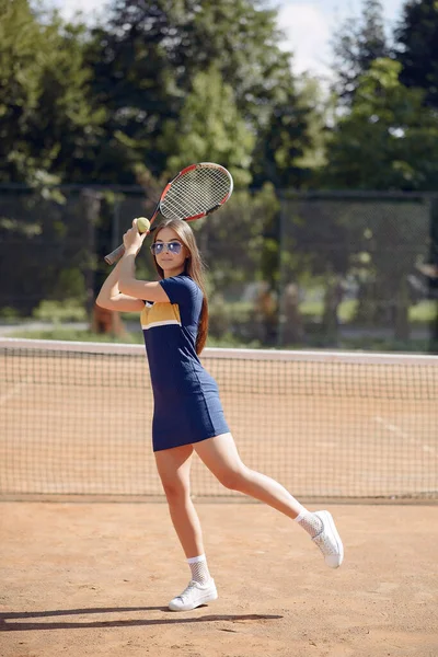 Caucasian female tennis player playing on the court outdoors — Stok fotoğraf