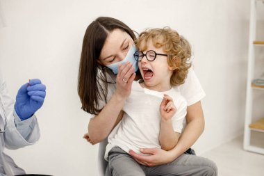 Little boy screaming because doctor is going to do vaccination