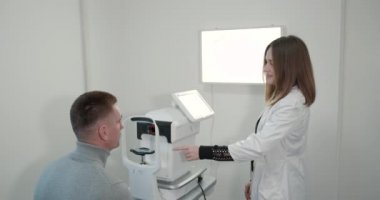 Young man with a short haircut in the office checking eyesight
