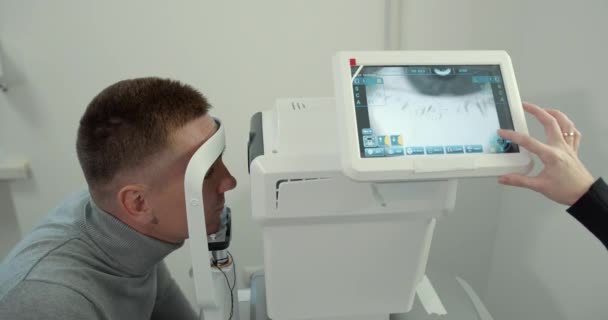 Молодой человек с короткой стрижкой в офисе проверяет зрение — стоковое видео