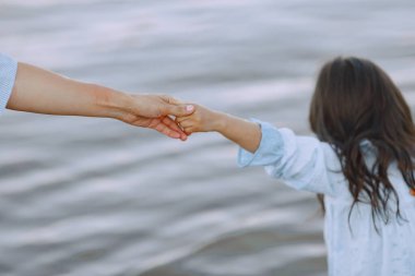 Anne ve kızı küçük nehirde oynuyorlar.