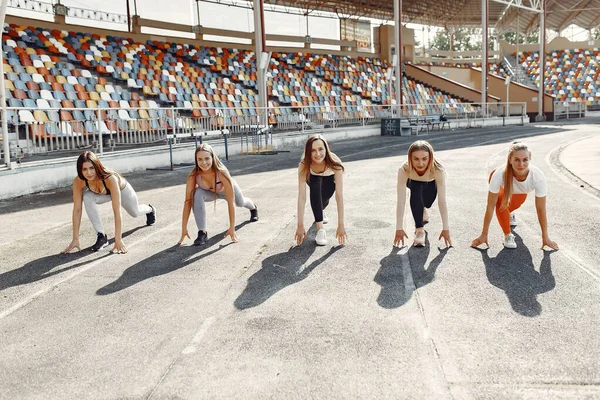 Five sports girls in a uniform training at the stadium — 스톡 사진