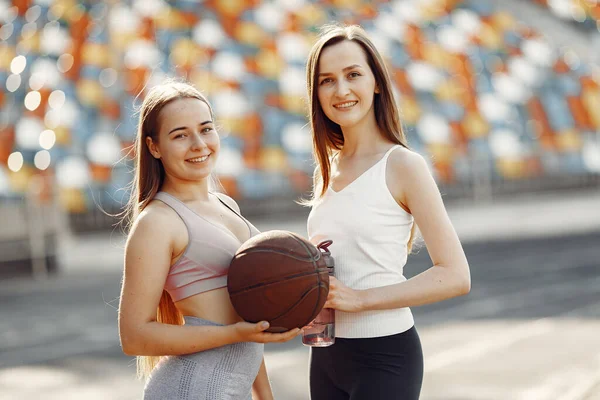 Sports girls in a uniform standing at the stadium — Stock Photo, Image