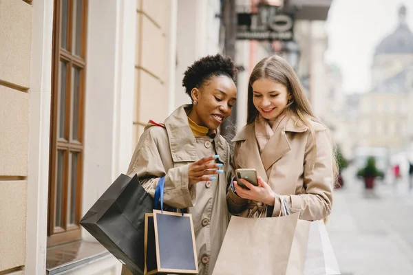 Shopping day. International girlfriends. Women in a city.