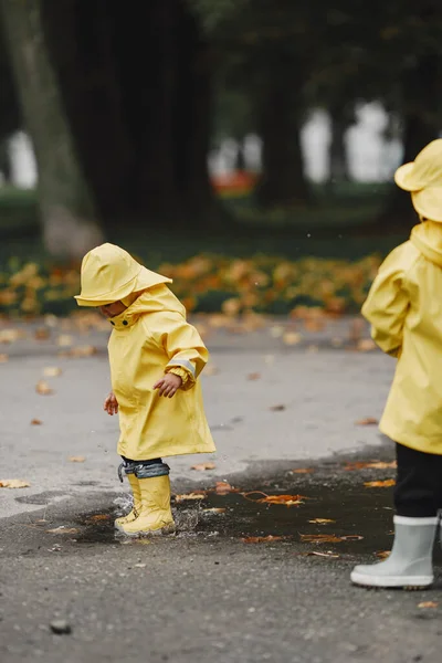 Kinder Einem Herbstpark Kinder Gelben Regenmänteln Menschen Haben Spaß Freien — Stockfoto