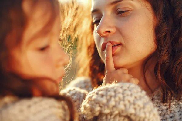 Family in a summer field. Sensual photo. Cute little girl in a knited sweater.