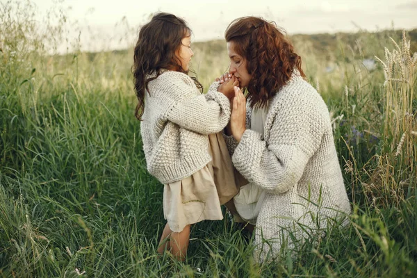 Family in a summer field. Sensual photo. Cute little girl in a knited sweater.