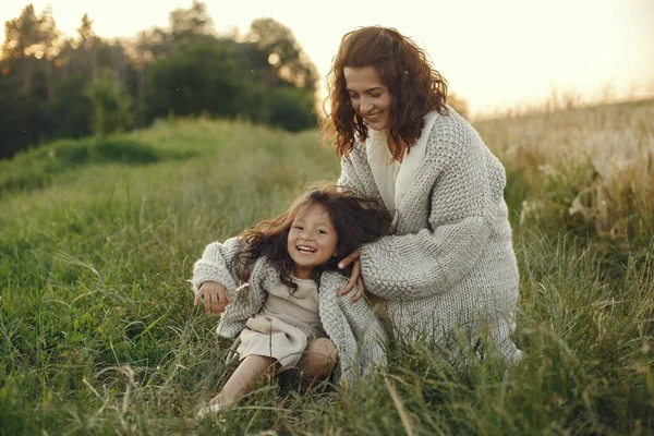 Family in a summer field. Sensual photo. Cute little girl in a knited sweater.