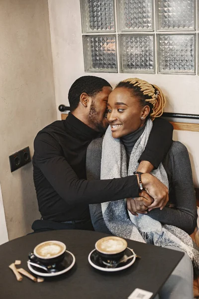 Two young people in cafe. African couple enjoying the time spending with each other.