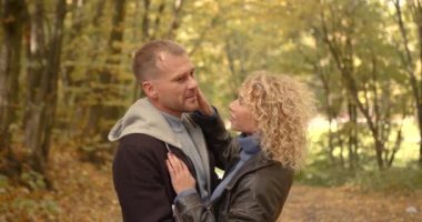 Young happy couple hugging in autumn park. Family leisure