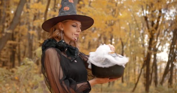 Halloween Concept Woman Dressed Witch Holding Toy Pot Autumn Forest — Stock Video