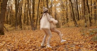 Parent and kid having time together outdoor in autumn park. Mother and child relations.