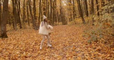 Parent and kid having time together outdoor in autumn park. Mother and child relations.