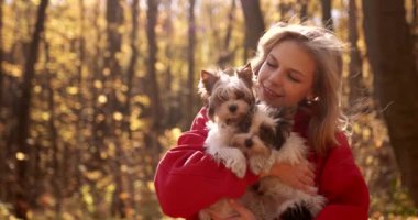 Attractive Young Woman in Fall Colors with Puppys