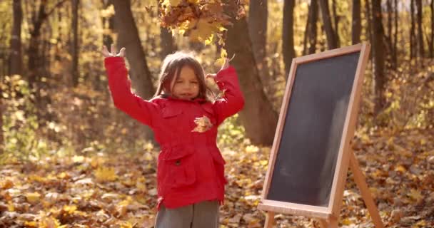 Schoolgirl Girl Red Throws Leaves School Board Autumn Forest Happy — Stockvideo