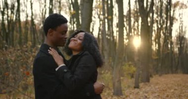 Young black couple in love cuddling in park, 4k shooting.