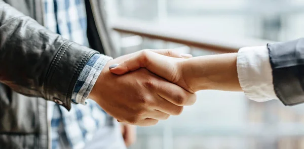 Man and woman hand shaking. Handshake after good cooperation, Businesswoman Shaking hands with Professional businessman after discussing good deal of contract. Business concept.