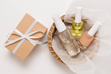 Organik kozmetik ürünleri ve bayram için hediyeler. Düz yerde, cam pompa şişesi, fırça kavanozu, beyaz arka planda kağıt sepette nemlendirici serum. Doğal Kozmetik SPA