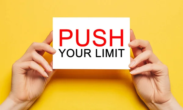 Ženské Ruce Drží Papír Textem Push Your Limit Žlutém Pozadí — Stock fotografie