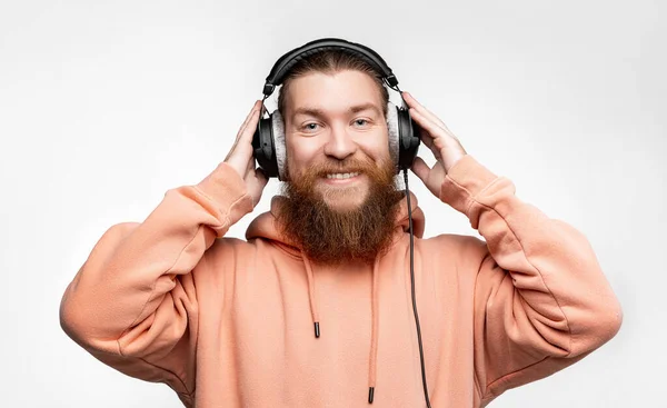 Scandinavian Handsome Contented Man Looks Smiles Listens Music Professional Headphones — Fotografia de Stock
