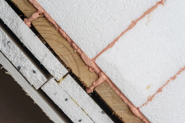 House insulation layers, styrofoam, polyurethane foam, wood, drywall