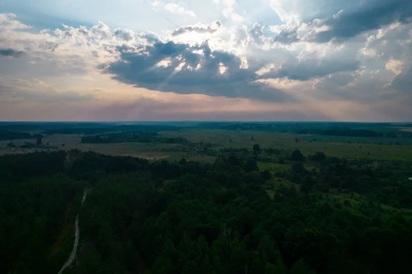 sunset in the clouds with the rays of the sun, view from the drone