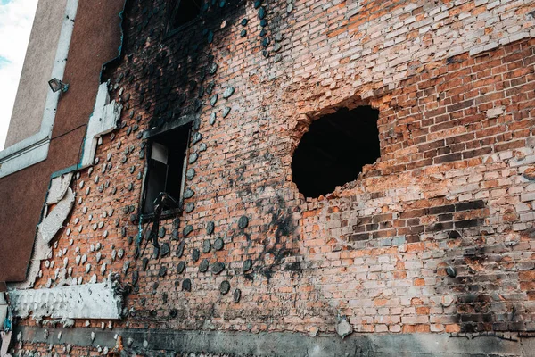 holes in the wall of the apartment from the shells of Russian invaders
