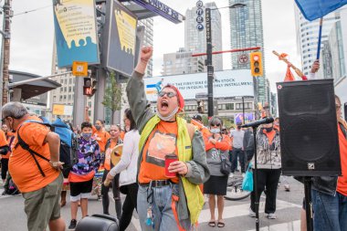 İnsanlar, Toronto, Ontario 'daki Dundas Meydanı' nda düzenlenen Turuncu Gömlek Günü ve Ulusal Gerçek ve Uzlaşma Günü 'ne iyileşmek, halkı bilinçlendirmek ve yerli bir topluluk olarak birlikte yükselmek için katılıyor..