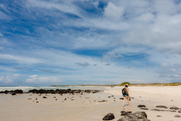 Galapagos Islands, Ecuador - March 15, 2022: People visiting Tortuga Bay, scenic beach 