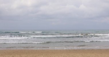 Denizin dalgaları sahilin kıyısında kırılır..