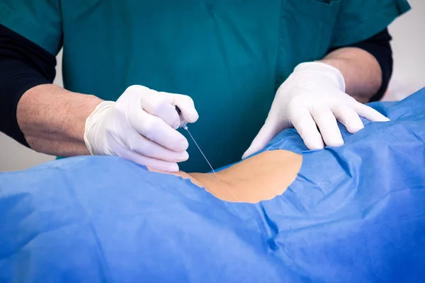 Ultrasound-guided infiltrative therapy for back pain treatment. Doctor practices the infiltration of drugs to the patient in the area affected by the pain