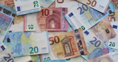 Çeşitli banknotlar halinde Euro banknotları. Masaya 20 avro, 50 avro, 10 avro, 5 avroluk banknotlar yığıldı. Karışık avro banknotlarının arkaplanı