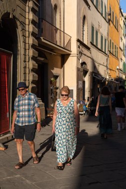 Cortona, Italy - July 15, 2022: people on the street in the small Tuscan town, home to the international photography festival 