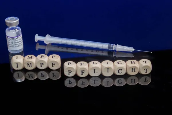 Bamberg, Almanya - 16.11.2021. Kavramsal resim zorunlu aşı, mektup küpleri, aşı şırıngası ve biontech-pfizer aşısı şişesi