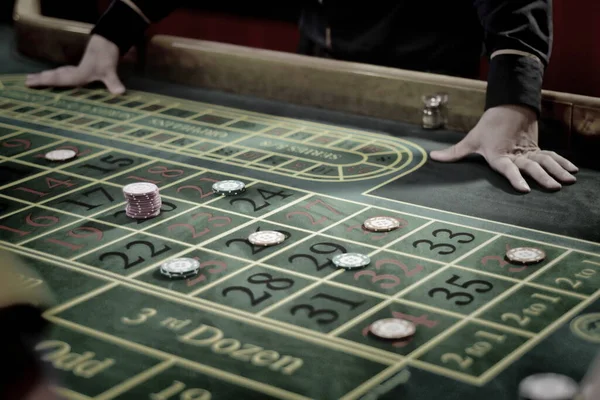The croupier accepts bets at the gaming casino