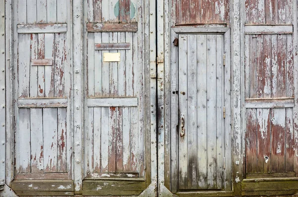 The old gates of the warehouse. Entrance to the territory in bad condition