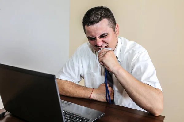 Office worker eating his badge. Occupational burnout. Bad work conditions. Unhappy manager with laptop. Summer heat. Meeting deadlines. Stressful job at the desk. Desperate man.