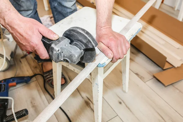 Man Cutting Baseboard Repair Works Indoors Renovation Flat Angle Grinder — Stock Photo, Image