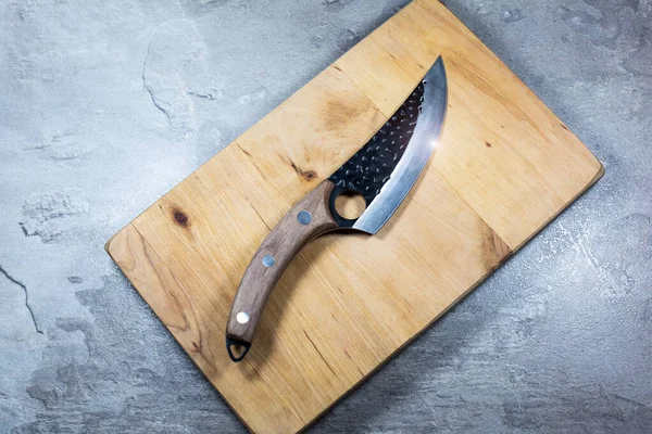 Big kitchen knife with wooden handle.