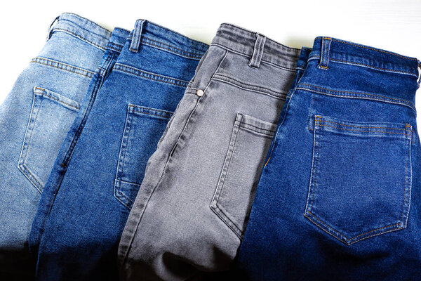Different colours of Old vintage Gray and Blue hipster jeans. Denim Cloth texture background. Natural fabrics textile.