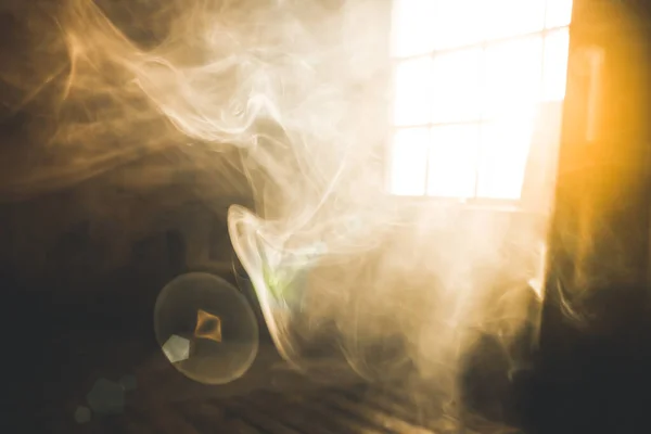 Sunshine window reflection on the wooden floor. Heavy smoke in loft design studio. Cinematic photo.