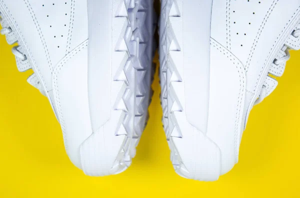 Modern Tornacipő Sárga Háttérrel Fehér Bőrcipő Nagy Talppal Tüskékkel Közelről — Stock Fotó