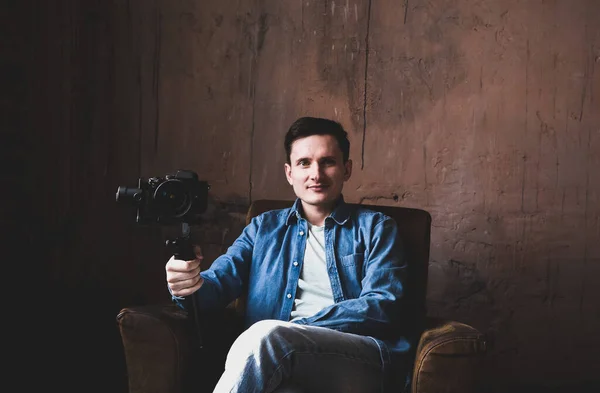 Portrait of Young video maker with camera on studio production.