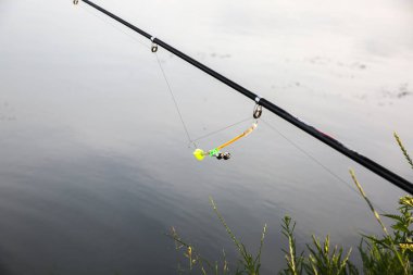 Fishing rods near the lake. Hobby outdoors. Catching fish in the nature with poles.
